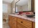 Bathroom featuring a wooden vanity with a granite countertop and decorative accessories, plus a tiled shower at 4892 Duncan Dr, Powder Springs, GA 30127