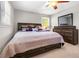 Comfortable bedroom with a bed, dresser, and two large windows, creating a cozy and inviting space at 4892 Duncan Dr, Powder Springs, GA 30127