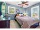 Comfortable bedroom with a bed, dresser, and two large windows, creating a cozy and inviting space at 4892 Duncan Dr, Powder Springs, GA 30127