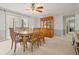 Formal dining room features a wooden table set for six, complemented by a ceiling fan and natural light at 4892 Duncan Dr, Powder Springs, GA 30127