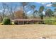 Spacious single-story home with a large front yard and mature trees, offering curb appeal and outdoor space at 4892 Duncan Dr, Powder Springs, GA 30127