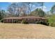 Charming brick home with well-manicured landscaping and symmetrical design, creating a welcoming first impression at 4892 Duncan Dr, Powder Springs, GA 30127