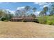 Charming ranch-style home with brick facade, surrounded by manicured shrubs and a large front yard at 4892 Duncan Dr, Powder Springs, GA 30127