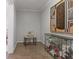 Hallway featuring tile flooring, wainscotting, artwork, and a decorative glass-fronted display, adding visual interest at 4892 Duncan Dr, Powder Springs, GA 30127