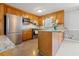 A bright kitchen with wood cabinets, granite countertops, and stainless steel appliances at 4892 Duncan Dr, Powder Springs, GA 30127