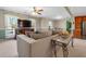 Bright living room view features a comfortable couch, TV, and a glimpse into the kitchen with wood cabinets at 4892 Duncan Dr, Powder Springs, GA 30127
