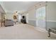 Bright living room with neutral paint, plush carpeting, and large windows, perfect for relaxation and entertainment at 4892 Duncan Dr, Powder Springs, GA 30127