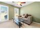 Cozy living room with a neutral sofa, glass coffee table, and bright natural light from the two large windows at 4892 Duncan Dr, Powder Springs, GA 30127