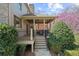 Inviting back porch with wood ceiling, stairs down to stone path, and flowering trees at 9860 Coleman Rd, Roswell, GA 30075