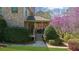 Charming backyard with covered porch, lush greenery, and a stone pathway at 9860 Coleman Rd, Roswell, GA 30075