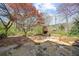 Large flagstone patio and outdoor fireplace are nestled in a lush backyard at 9860 Coleman Rd, Roswell, GA 30075