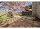 Backyard stone patio featuring an outdoor fireplace perfect for relaxation and entertaining at 9860 Coleman Rd, Roswell, GA 30075