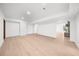 Spacious basement area with light wood-look flooring and recessed lighting at 9860 Coleman Rd, Roswell, GA 30075