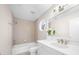 Well-lit bathroom featuring a tub, shower, window and modern sink and vanity at 9860 Coleman Rd, Roswell, GA 30075