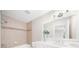 Well-lit bathroom featuring a tub, shower, and modern sink and vanity at 9860 Coleman Rd, Roswell, GA 30075