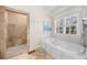 Beautiful bathroom features a soaking tub and walk-in shower with natural light at 9860 Coleman Rd, Roswell, GA 30075