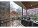 Covered porch showcasing a cozy seating area with scenic views framed by lush greenery at 9860 Coleman Rd, Roswell, GA 30075