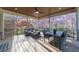 Enjoy outdoor dining on this covered porch with a ceiling fan and charming views of the landscape at 9860 Coleman Rd, Roswell, GA 30075