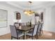 Bright dining area with hardwood floors, modern lighting, art piece, and staircase view at 9860 Coleman Rd, Roswell, GA 30075