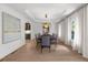 Bright dining area with hardwood floors, modern lighting, and butler's pantry view at 9860 Coleman Rd, Roswell, GA 30075