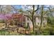 Brick home with well-maintained landscaping, flowering trees, and partial view of the backyard at 9860 Coleman Rd, Roswell, GA 30075