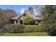 Beautiful brick home with manicured lawn, flowering trees, and privacy landscaping at 9860 Coleman Rd, Roswell, GA 30075