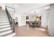 Foyer view showcasing hardwood floors, staircase, dining room with modern lighting, and elegant decor at 9860 Coleman Rd, Roswell, GA 30075