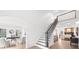 A grand foyer featuring an open staircase, hardwood floors, and views of the office and living room at 9860 Coleman Rd, Roswell, GA 30075