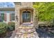 Elegant stone facade and double doors create a grand entrance to this inviting home at 9860 Coleman Rd, Roswell, GA 30075