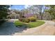 A sprawling lawn and circular driveway highlight this grand home's inviting exterior at 9860 Coleman Rd, Roswell, GA 30075