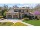 Stately brick home featuring a two-car garage, manicured landscaping, and a charming covered porch at 9860 Coleman Rd, Roswell, GA 30075