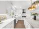 Spacious kitchen featuring white cabinets, hardwood floors and stainless steel appliances at 9860 Coleman Rd, Roswell, GA 30075
