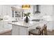 Marble island with grey chairs and modern lighting at 9860 Coleman Rd, Roswell, GA 30075