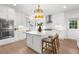 Modern kitchen featuring a center island, white cabinetry, stainless appliances, and hardwood floors at 9860 Coleman Rd, Roswell, GA 30075