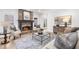 A cozy living room with a stone fireplace, neutral color scheme, and decorative area rug at 9860 Coleman Rd, Roswell, GA 30075