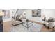 Bright living room featuring a neutral sofa, modern art, and stylish decor at 9860 Coleman Rd, Roswell, GA 30075