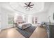Spacious main bedroom with trey ceiling, large bed, and abundant natural light at 9860 Coleman Rd, Roswell, GA 30075