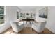 Bright home office with large windows, hardwood floors, stylish furnishings, and a lovely area rug at 9860 Coleman Rd, Roswell, GA 30075