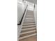 Wooden staircase featuring dark railings and bright white risers and skirt board at 9860 Coleman Rd, Roswell, GA 30075