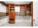 Large walk-in closet with custom wood shelving, drawers, and carpeted floor at 9860 Coleman Rd, Roswell, GA 30075