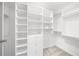 Organized white walk-in closet with multiple shelves and hanging rods at 9860 Coleman Rd, Roswell, GA 30075