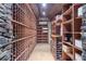 Elaborate wine cellar featuring custom wooden racks, stone accents, and sophisticated design at 9860 Coleman Rd, Roswell, GA 30075
