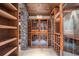 Stunning wine cellar with custom wood racking and stone accents for the discerning wine collector at 9860 Coleman Rd, Roswell, GA 30075