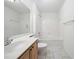 Bright bathroom with vanity, toilet, and shower-tub combo with white tile and coordinating marble-look floors at 112 Bentley Pl, Tucker, GA 30084