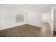 Bright bedroom with hardwood floors, large window, and access to other rooms at 112 Bentley Pl, Tucker, GA 30084
