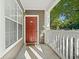 Charming unit entrance with a red door, covered porch, and well-kept exterior at 112 Bentley Pl, Tucker, GA 30084