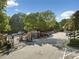 Bentley Place entrance with gated entry and mature trees on sunny day at 112 Bentley Pl, Tucker, GA 30084