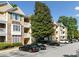 Exterior of Bentley Place showing well-maintained building, landscaping, and parking at 112 Bentley Pl, Tucker, GA 30084