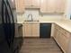 Kitchen featuring stainless steel appliances, light wood cabinetry, and laminate flooring at 112 Bentley Pl, Tucker, GA 30084