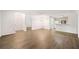 Open-concept living room with hardwood floors and access to the kitchen at 112 Bentley Pl, Tucker, GA 30084